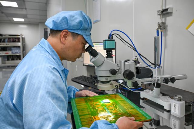(260709) -- SHANGHAI, July 9, 2026 (Xinhua) -- A staff member works at a testing workshop of a chips testing service platform at the Zhangjiang Hi-Tech 895 Incubator in Pudong New Area, east China's Shanghai, on July 8, 2026. Located in Shanghai's Pudong New Area, the Zhangjiang Hi-Tech 895 Incubator, a specialized entrepreneurship service platform, has incubated more than 1,600 innovative enterprises since its establishment in 2015. 
   Equipped with advanced testing facilities, including a 4,000-square-meter clean test workshop, the incubator provides one-stop public testing services and shared office space for startups. Its testing platform supports the development of high-performance computing chips, large-scale System-on-a-Chip (SoC), memory chips, sensor chips and mixed-signal chips, helping technology startups reduce costs and accelerate innovation. (Xinhua/Chen Shuo)