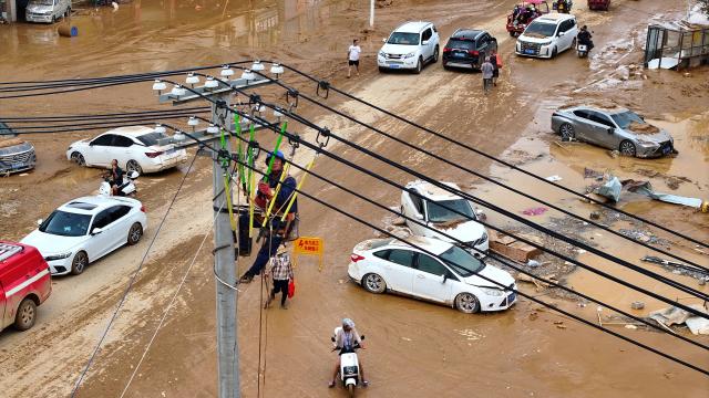 (260709) -- NANNING, July 9, 2026 (Xinhua) -- A drone photo shows a power worker restoring electricity in Yunbiao Town of Hengzhou City, south China's Guangxi Zhuang Autonomous Region, July 9, 2026. Recent extreme rainstorms triggered by Typhoon Maysak, the 10th typhoon of the year, have caused severe flooding in parts of Guangxi in the Pearl River basin.
  Guangxi is continuing its search and rescue operations for missing persons, enhancing resettlement services for affected residents and advancing post-disaster reconstruction. (Xinhua/Huang Xiaobang)