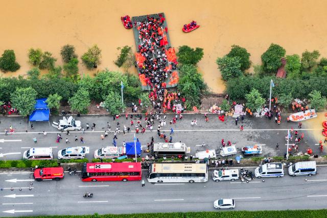 (260709) -- NANNING, July 9, 2026 (Xinhua) -- An aerial drone photo shows rescuers evacuating trapped students in Guigang City, south China's Guangxi Zhuang Autonomous Region, July 9, 2026. Recent extreme rainstorms triggered by Typhoon Maysak, the 10th typhoon of the year, have caused severe flooding in parts of Guangxi in the Pearl River basin.
  Guangxi is continuing its search and rescue operations for missing persons, enhancing resettlement services for affected residents and advancing post-disaster reconstruction. (Xinhua/Zhou Hua)