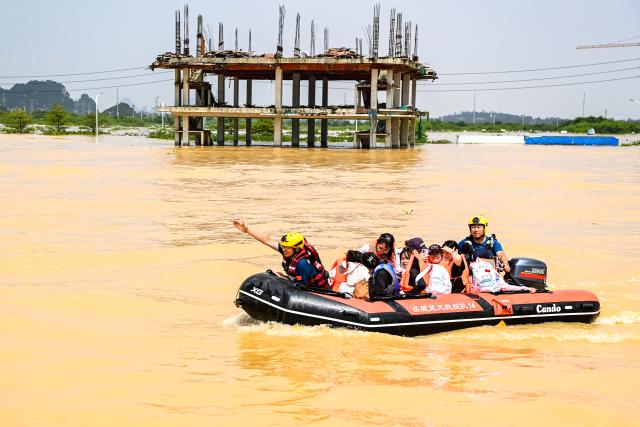 (260709) -- NANNING, July 9, 2026 (Xinhua) -- Rescuers evacuate trapped students in Guigang City, south China's Guangxi Zhuang Autonomous Region, July 9, 2026. Recent extreme rainstorms triggered by Typhoon Maysak, the 10th typhoon of the year, have caused severe flooding in parts of Guangxi in the Pearl River basin.
  Guangxi is continuing its search and rescue operations for missing persons, enhancing resettlement services for affected residents and advancing post-disaster reconstruction. (Xinhua/Cao Yiming)