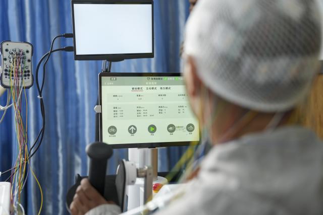 (260709) -- LHASA, July 9, 2026 (Xinhua) -- A patient with high paraplegia receives brain-computer interface (BCI) assisted neurorehabilitation treatment at Lhasa People's Hospital in Lhasa, southwest China's Xizang Autonomous Region, July 9, 2026. The first plateau BCI clinical application center in Xizang was officially inaugurated at Lhasa People's Hospital on Thursday, marking a significant step for the region in leveraging cutting-edge technology to address intractable neurological diseases.
 As a transformative human-computer interaction solution, BCI technology has shown great potential in the neurological rehabilitation field.
 This year, a medical assistance team from Beijing Tiantan Hospital to Xizang introduced the BCI technology to the region, which will promote the implementation of cutting-edge medical technologies to benefit people in Xizang. (Xinhua/Jigme Dorje)