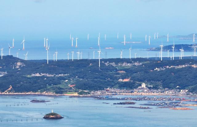 (260709) -- FUZHOU, July 9, 2026 (Xinhua) -- A drone photo taken on June 30, 2026 shows offshore and onshore wind farms in Pingtan County, southeast China's Fujian Province.
  The province of Fujian is rich in high-quality clean energy resources like wind power, solar energy, hydro power and nuclear power.
   In recent years, Fujian has relied on its local clean energy endowment and geographical advantages to build its smart new power grids and develop the region as a major clean energy hub in southeast China. 
    It has accelerated the construction of power transmission channels, steadily upgraded urban and rural distribution networks, promoted the construction of smart micro-grids, continuously revitalized its clean energy advantages, and consolidated the foundation of energy security through the construction of smart new power grids. (Xinhua/Lin Shanchuan)