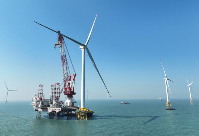 (260709) -- FUZHOU, July 9, 2026 (Xinhua) -- A drone photo taken on Jan. 13, 2026 shows part of an offshore wind farm and a 2,000-ton jack-up offshore wind turbine installation platform on the waters of southern Fujian in southwest China.
  The province of Fujian is rich in high-quality clean energy resources like wind power, solar energy, hydro power and nuclear power.
   In recent years, Fujian has relied on its local clean energy endowment and geographical advantages to build its smart new power grids and develop the region as a major clean energy hub in southeast China. 
    It has accelerated the construction of power transmission channels, steadily upgraded urban and rural distribution networks, promoted the construction of smart micro-grids, continuously revitalized its clean energy advantages, and consolidated the foundation of energy security through the construction of smart new power grids. (Xinhua/Lin Shanchuan)