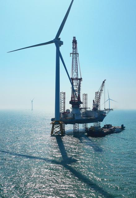 (260709) -- FUZHOU, July 9, 2026 (Xinhua) -- A drone photo taken on Jan. 13, 2026 shows part of an offshore wind farm and a 2,000-ton jack-up offshore wind turbine installation platform on the waters of southern Fujian in southwest China.
  The province of Fujian is rich in high-quality clean energy resources like wind power, solar energy, hydro power and nuclear power.
   In recent years, Fujian has relied on its local clean energy endowment and geographical advantages to build its smart new power grids and develop the region as a major clean energy hub in southeast China. 
    It has accelerated the construction of power transmission channels, steadily upgraded urban and rural distribution networks, promoted the construction of smart micro-grids, continuously revitalized its clean energy advantages, and consolidated the foundation of energy security through the construction of smart new power grids. (Xinhua/Lin Shanchuan)