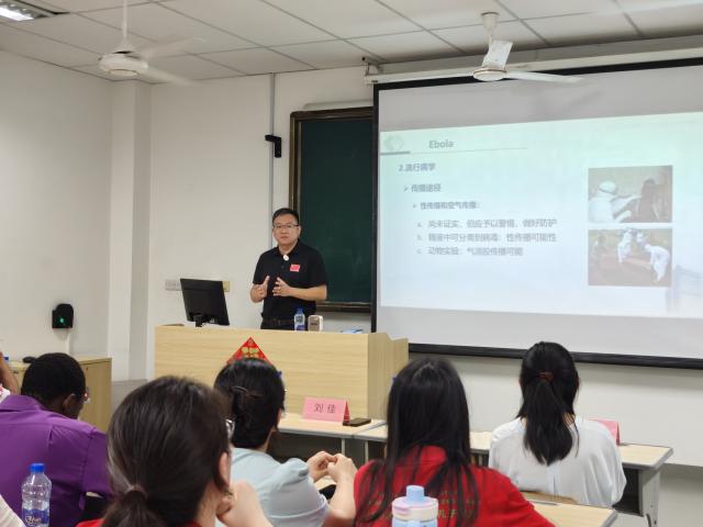 (260709) -- DAR ES SALAAM, July 9, 2026 (Xinhua) -- Photo taken with a mobile phone shows Liu Jia, leader of the Chinese medical team, giving a lecture on infectious diseases at the Confucius Institute at the University of Dar es Salaam in Dar es Salaam, Tanzania, July 8, 2026. TO GO WITH "Chinese medical team promotes TCM, infectious disease prevention in Tanzania" (The 28th batch of the Chinese medical team in mainland Tanzania/Handout via Xinhua)