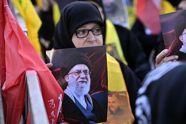 (260709) -- BEIRUT, July 9, 2026 (Xinhua) -- Photo taken on July 8, 2026 shows a woman holding a portrait of Iran's late Supreme Leader Ali Khamenei at a memorial ceremony in Beirut's southern suburbs, Lebanon. (Photo by Bilal Jawich/Xinhua)