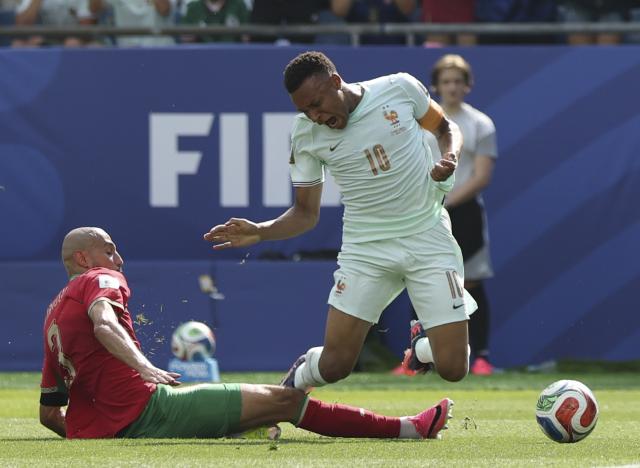 (260710) -- BOSTON, July 10, 2026 (Xinhua) -- Kylian Mbappe (R) of France is fouled by Noussair Mazraoui of Morocco during the quarter final match between France and Morocco at the 2026 FIFA World Cup at Boston Stadium in Boston, the United States, July 9, 2026. (Xinhua/Zhang Chen)