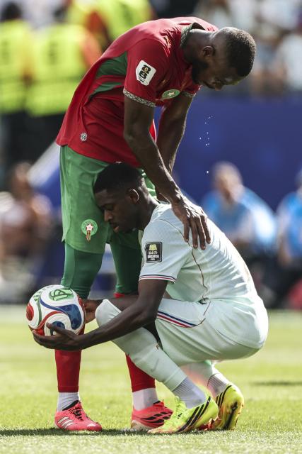 (260710) -- BOSTON, July 10, 2026 (Xinhua) -- Issa Diop (L) of Morocco and Ousmane Dembele of France react during the quarter final match between France and Morocco at the 2026 FIFA World Cup at Boston Stadium in Boston, the United States, July 9, 2026. (Xinhua/Zhang Chen)