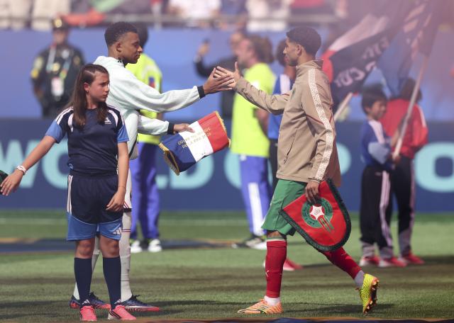 (260710) -- BOSTON, July 10, 2026 (Xinhua) -- Kylian Mbappe (back, L) of France greets Achraf Hakimi (R) of Morocco before the quarter final match between France and Morocco at the 2026 FIFA World Cup at Boston Stadium in Boston, the United States, July 9, 2026. (Xinhua/Xu Zijian)