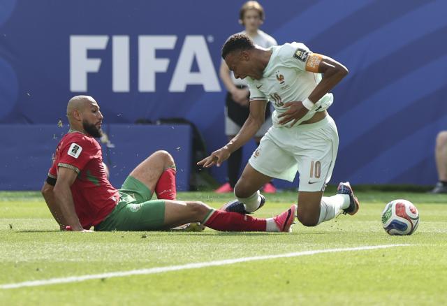 (260710) -- BOSTON, July 10, 2026 (Xinhua) -- Kylian Mbappe (R) of France is fouled by Noussair Mazraoui of Morocco during the quarter final match between France and Morocco at the 2026 FIFA World Cup at Boston Stadium in Boston, the United States, July 9, 2026. (Xinhua/Zhang Chen)