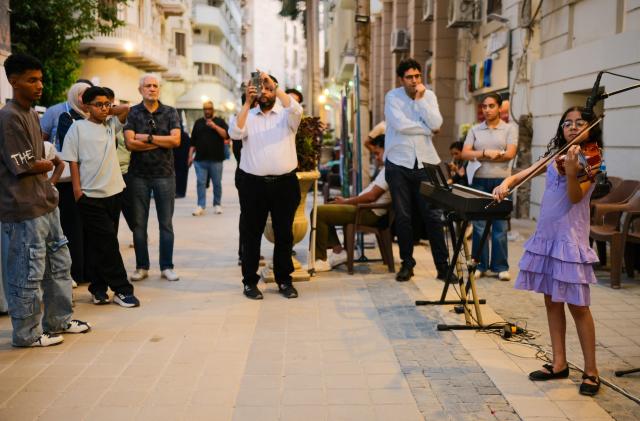 (260709) -- CAIRO, July 9, 2026 (Xinhua) -- A young violinist performs in downtown Cairo, Egypt, July 9, 2026. Egypt's government recently launched the "Street of Art" initiative, aiming to transform the streets and squares of the capital, Cairo, into open-air cultural spaces. Every Thursday through Saturday evening, the public can enjoy free cultural activities such as poetry readings, musical performances, and visual art exhibitions, attracting active participation from both citizens and tourists. (Xinhua/Xin Mengchen)
