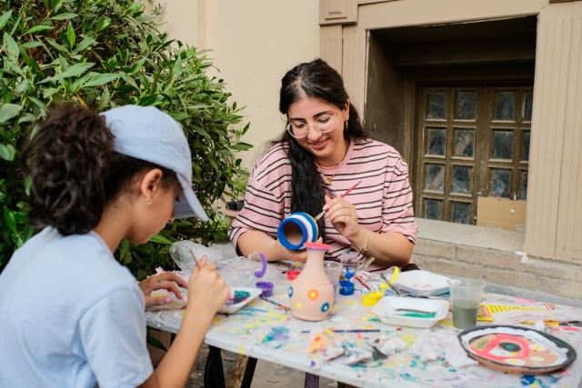(260709) -- CAIRO, July 9, 2026 (Xinhua) -- Tourists experience pottery painting in downtown Cairo, Egypt, July 9, 2026. Egypt's government recently launched the "Street of Art" initiative, aiming to transform the streets and squares of the capital, Cairo, into open-air cultural spaces. Every Thursday through Saturday evening, the public can enjoy free cultural activities such as poetry readings, musical performances, and visual art exhibitions, attracting active participation from both citizens and tourists. (Xinhua/Xin Mengchen)