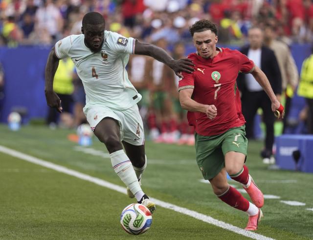 (260710) -- BOSTON, July 10, 2026 (Xinhua) -- Dayot Upamecano (L) of France vies with Chemsdine Talbi of Morocco during the quarter final match between France and Morocco at the 2026 FIFA World Cup at Boston Stadium in Boston, the United States, July 9, 2026. (Xinhua/Lui Siu Wai)