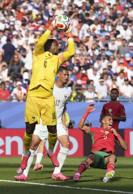 (260710) -- BOSTON, July 10, 2026 (Xinhua) -- Mike Maignan (front), goalkeeper of France makes a save during the quarter final match between France and Morocco at the 2026 FIFA World Cup at Boston Stadium in Boston, the United States, July 9, 2026. (Xinhua/Lui Siu Wai)