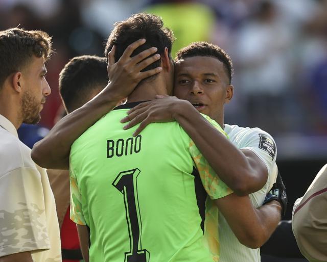 (260710) -- BOSTON, July 10, 2026 (Xinhua) -- Kylian Mbappe (R) of France hugs Yassine Bounou, goalkeeper of Morocco after the quarter final match between France and Morocco at the 2026 FIFA World Cup at Boston Stadium in Boston, the United States, July 9, 2026. (Xinhua/Hu Xingyu)