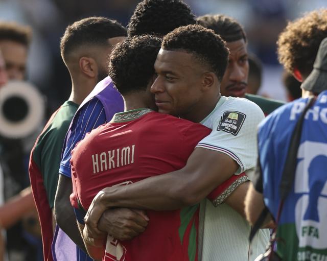 (260710) -- BOSTON, July 10, 2026 (Xinhua) -- Kylian Mbappe (R) of France hugs Achraf Hakimi of Morocco after the quarter final match between France and Morocco at the 2026 FIFA World Cup at Boston Stadium in Boston, the United States, July 9, 2026. (Xinhua/Hu Xingyu)