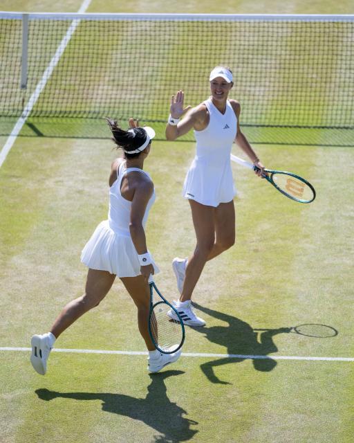 (260710) -- LONDON, July 10, 2026 (Xinhua) -- Guo Hanyu/Kristina Mladenovic(R) react during the women's doubles quarterfinal match between Katerina Siniakova (the Czech Republic)/Taylor Townsend (the United States of America) and Guo Hanyu (China)/Kristina Mladenovic (France) at the Wimbledon Tennis Championships in London, Britain, on July 9, 2026. (Photo by Stephen Chung/Xinhua)
