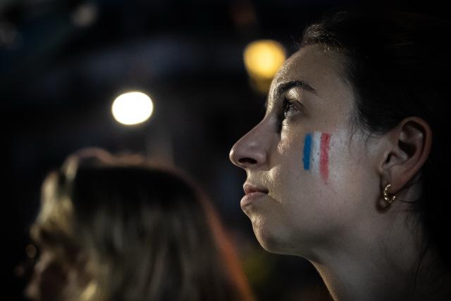 (260710) -- PARIS, July 10, 2026 (Xinhua) -- A French fan watches a broadcast of the 2026 FIFA World Cup quarterfinal football match between France and Morocco in Paris, France, July 9, 2026. (Photo by Aurelien Morissard/Xinhua)