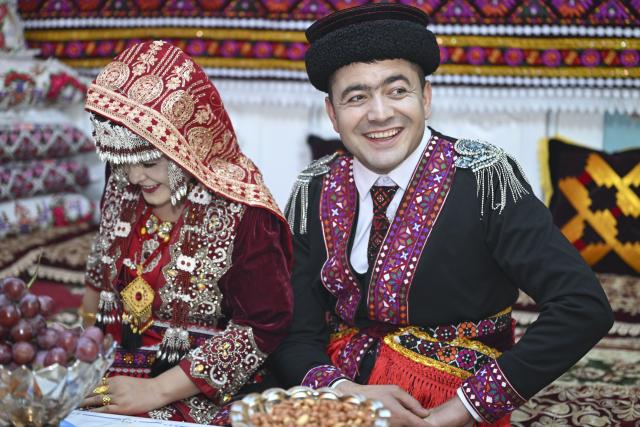 (260710) -- BEIJING, July 10, 2026 (Xinhua) -- Nurkerim and his bride pose for photos at home in Taxkorgan Tajik Autonomous County, northwest China's Xinjiang Uygur Autonomous Region, June 30, 2026. This summer, happiness filled the air around the home of herdsman Duri Jarman. His youngest son Nurkerim tied the knot with his beloved woman. Weddings of the Tajik ethnic group usually last three days. Inscribed on the national intangible cultural heritage list in 2008, the wedding customs of the Tajik ethnic group maintain unique traditions and are always described as festivals of music, dance and food to showcase the resplendent newlyweds and their propitious marriage. (Xinhua/Hu Huhu)
