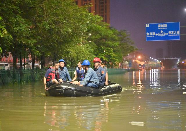 (260710) -- GUIGANG, July 10, 2026 (Xinhua) -- Rescuers take a boat through floodwater in Guigang, south China's Guangxi Zhuang Autonomous Region, July 9, 2026.
  Guigang has suffered severe flooding due to torrential rains brought by Typhoon Maysak and upstream inflows. Local authorities have mobilized rescue forces to work around the clock, making every effort to ensure basic living needs for stranded residents. (Xinhua/Zhou Hua)
