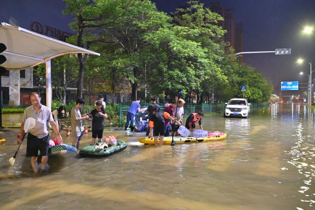 (260710) -- GUIGANG, July 10, 2026 (Xinhua) -- Rescuers wade through floodwater to deliver supplies to stranded residents in Guigang, south China's Guangxi Zhuang Autonomous Region, July 9, 2026.
  Guigang has suffered severe flooding due to torrential rains brought by Typhoon Maysak and upstream inflows. Local authorities have mobilized rescue forces to work around the clock, making every effort to ensure basic living needs for stranded residents. (Xinhua/Zhou Hua)