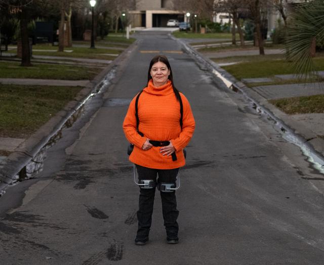 (260709) -- BUENOS AIRES, July 9, 2026 (Xinhua) -- Maria Laura Biscaglia stands with the help of a robotic exoskeleton device in Buenos Aires, Argentina, on July 4, 2026. TO GO WITH "Feature: Chinese robotic exoskeleton gives Argentine woman new hope" (Photo by Juan Manuel Foglia/Xinhua)
