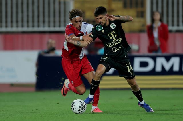 (260710) -- NOVI SAD, July 10, 2026 (Xinhua) -- Ferencvaros' Attila Osvath (R) vies with Vojvodina's Stefan Mitrovic during the 1st leg of the first qualifying round football match between Vojvodina and Ferencvaros at the 2026/27 UEFA Europa League in Novi Sad, Serbia, on July 9, 2026. (Photo by Predrag Milosavljevic/Xinhua)