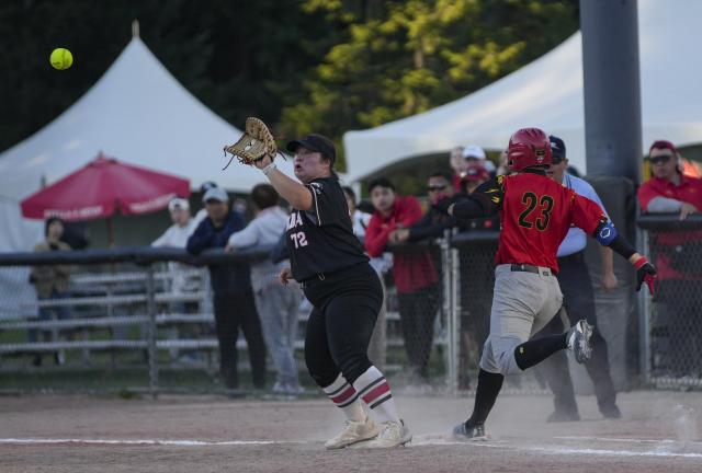 (260710) -- SURREY, July 10, 2026 (Xinhua) -- Gui Yuanyuan (R) of China competes during a round-robin match between China and Canada at the 2026 Canada Cup International Softball Championship in Surrey, British Columbia, Canada, July 9, 2026. (Photo by Liang Sen/Xinhua)