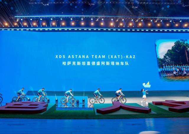 (260710) -- XINING, July 10, 2026 (Xinhua) -- Cyclists of XDS Astana Team of Kazakhstan enter the stage during the opening ceremony of The 25th "Tour of Magnificent Qinghai" International Road Cycling Race in Xining, northwest China's Qinghai Province, July 10, 2026. (Xinhua/Du Xiaowei)