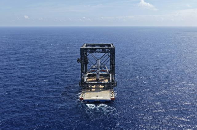 (260710) -- SOUTH CHINA SEA, July 10, 2026 (Xinhua) -- This drone photo taken on July 10, 2026 shows the successful capture of the returned first stage of Long March-10B carrier rocket on a seaborne platform via a net-capture system. China successfully launched the Long March-10B carrier rocket at the Hainan commercial spacecraft launch site in south China's Hainan Province on Friday, achieving its first-ever controlled recovery of a carrier rocket's first stage. (Xinhua/Xing Guangli)