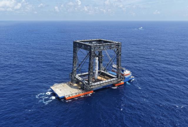 (260710) -- SOUTH CHINA SEA, July 10, 2026 (Xinhua) -- This drone photo taken on July 10, 2026 shows the successful capture of the returned first stage of Long March-10B carrier rocket on a seaborne platform via a net-capture system. China successfully launched the Long March-10B carrier rocket at the Hainan commercial spacecraft launch site in south China's Hainan Province on Friday, achieving its first-ever controlled recovery of a carrier rocket's first stage. (Xinhua/Xing Guangli)