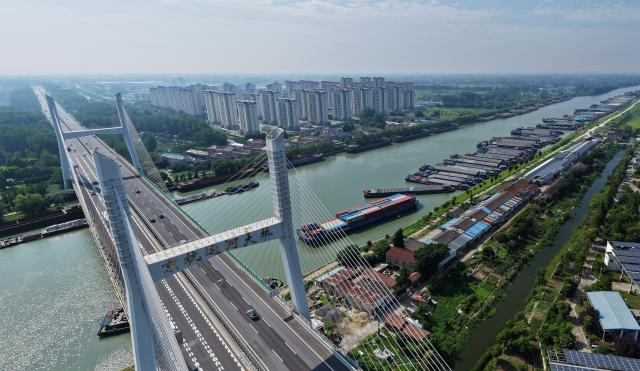 (260710) -- BEIJING, July 10, 2026 (Xinhua) -- An aerial drone photo taken on July 10, 2026 shows a panoramic view of vessels mooring along the shore in response to the incoming typhoon at the Grand Canal in Yangzhou, east China's Jiangsu Province. China's national observatory on Friday renewed an orange alert for Typhoon Bavi, the ninth typhoon of 2026, which is expected to bring gales and heavy rain to eastern China. Affected regions are on high alert, with all prevention and response measures fully implemented to safeguard people's lives and property. (Photo by Meng Delong/Xinhua)
