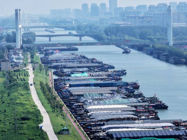 (260710) -- BEIJING, July 10, 2026 (Xinhua) -- An aerial drone photo taken on July 10, 2026 shows vessels mooring along the shore in response to the incoming typhoon at the Grand Canal in Yangzhou, east China's Jiangsu Province. China's national observatory on Friday renewed an orange alert for Typhoon Bavi, the ninth typhoon of 2026, which is expected to bring gales and heavy rain to eastern China. Affected regions are on high alert, with all prevention and response measures fully implemented to safeguard people's lives and property. (Photo by Meng Delong/Xinhua)