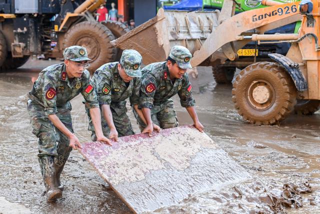 (260710) -- NANNING, July 10, 2026 (Xinhua) -- Rescuers help clear a road in Guigang, south China's Guangxi Zhuang Autonomous Region, July 10, 2026. The local authorities beef up restoration efforts after torrential rains caused by Typhoon Maysak. (Xinhua/Cao Yiming)