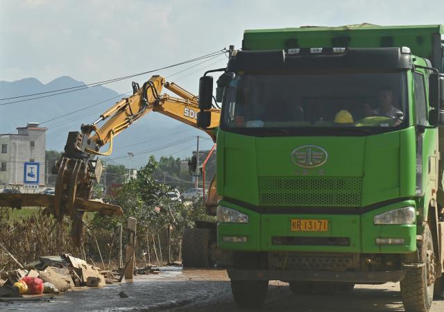 (260710) -- NANNING, July 10, 2026 (Xinhua) -- Workers clear a road in Guigang, south China's Guangxi Zhuang Autonomous Region, July 10, 2026. The local authorities beef up restoration efforts after torrential rains caused by Typhoon Maysak. (Xinhua/Zhou Hua)