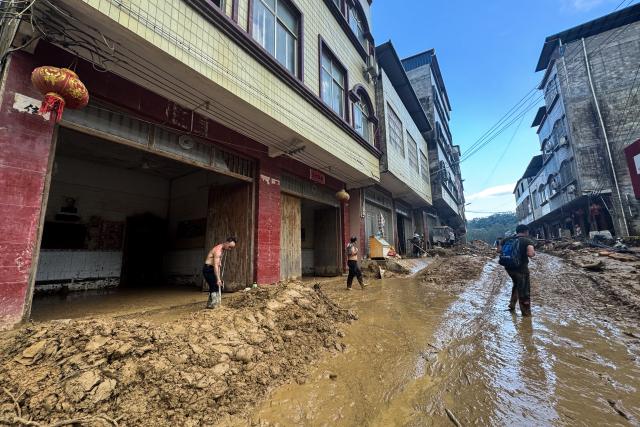(260710) -- NANNING, July 10, 2026 (Xinhua) -- Residents clear a road in Zhenlong Township in Hengzhou City, south China's Guangxi Zhuang Autonomous Region, July 10, 2026. The local authorities beef up restoration efforts after torrential rains caused by Typhoon Maysak. (Xinhua/Huang Xiaobang)