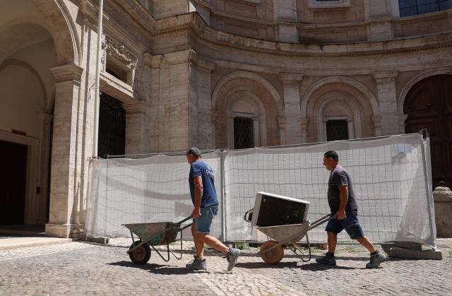 (260710) -- ROME, July 10, 2026 (Xinhua) -- Workers carry air conditioning units in Rome, Italy, July 10, 2026. A new round of heatwave is underway around Italy, with the average temperature consistently around 35 degrees Celsius and peaks exceeding 40 degrees Celsius. (Xinhua/Wang Kaiyan)