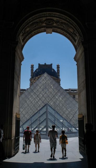 (260710) -- PARIS, July 10, 2026 (Xinhua) -- Visitors are seen near the Louvre Museum during the heatwave in Paris, France, July 10, 2026. The Louvre Museum announced on Thursday that it will close two hours earlier than usual from Friday through next Monday as France braces for another heatwave. (Xinhua/Wu Huiwo)