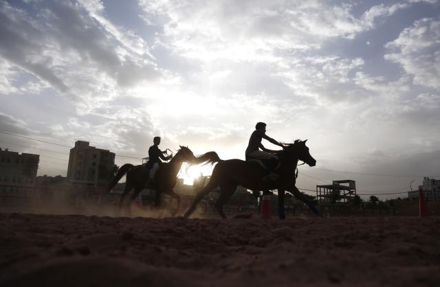 (260710) -- SANAA, July 10, 2026 (Xinhua) -- Two riders train at an equestrian club in Sanaa, Yemen, on July 9, 2026. Horse lovers and trainers gathered at an equestrian club in Yemen's capital Sanaa to promote equestrian culture and encourage horse riding ahead of World Horse Day, which falls on July 11. (Photo by Mohammed Mohammed/Xinhua)