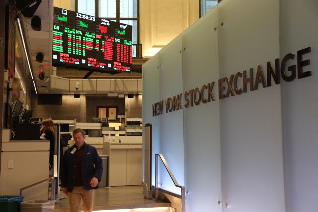 (260710) -- NEW YORK, July 10, 2026 (Xinhua) -- A trader walks on the trading floor of the New York Stock Exchange in New York, the United States, on July 10, 2026. U.S. stocks ended higher on Friday. The Dow Jones Industrial Average rose 149.6 points, or 0.29 percent, to 52,637.01. The S&P 500 added 31.75 points, or 0.42 percent, to 7,575.39. The Nasdaq Composite Index increased by 74.72 points, or 0.29 percent, to 26,281.61. (Xinhua/Liu Yanan)