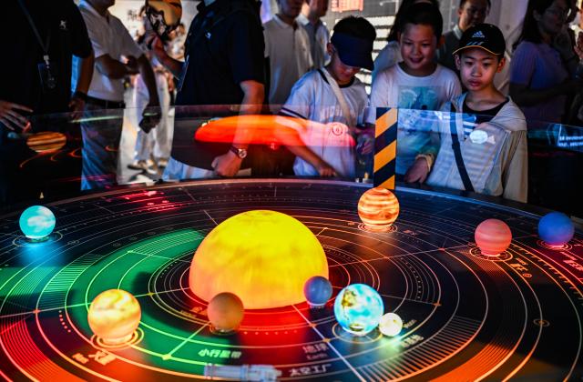 (260711) -- BEIJING, July 11, 2026 (Xinhua) -- Children visit the exhibition centered on the "Nantianmen Project" in Beijing, capital of China, July 9, 2026.
  The exhibition opened to public here on Wednesday. The "Nantianmen Project" is China's homegrown sci-fi aerospace intellectual property. (Xinhua/Yan Linyun)