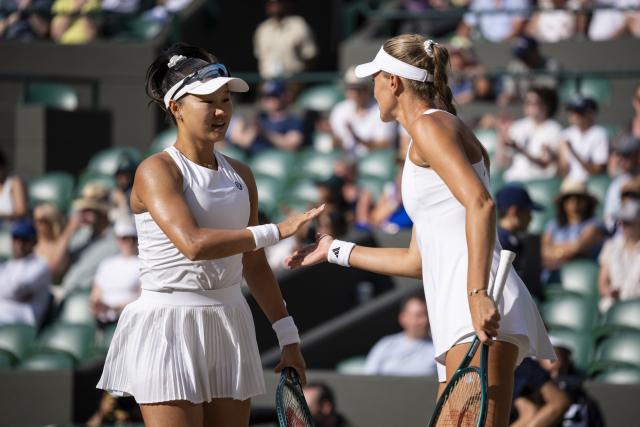 (260711) -- LONDON, July 11, 2026 (Xinhua) -- Guo Hanyu (L)/Kristina Mladenovic react during the women's doubles semi-finals match between Guo Hanyu (China)/Kristina Mladenovic (France) and Jiang Xinyu/Xu Yifan of China at the Wimbledon Tennis Championships in London, Britain, on July 10, 2026. (Photo by Stephen Chung/Xinhua)