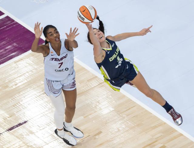 (260711) -- MONTREAL, July 11, 2026 (Xinhua) -- Alanna Smith (R) of Dallas Wings goes up for a layup during the 2026 WNBA regular season basketball game between Toronto Tempo and Dallas Wings in Montreal, Canada, on July 10, 2026. (Photo by Zou Zheng/Xinhua)