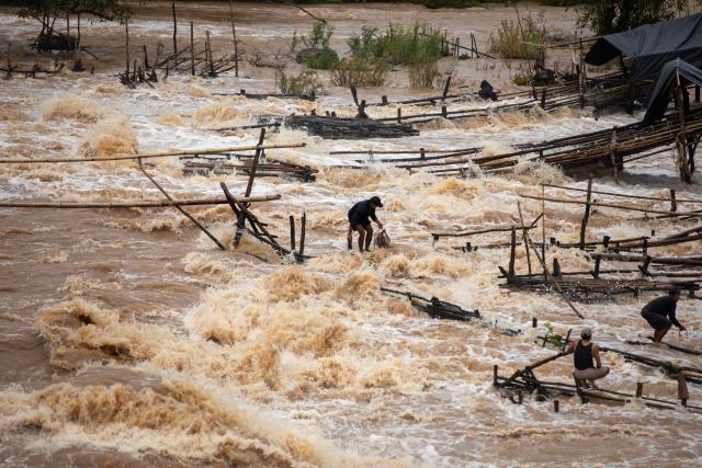 (260711) -- CHAMPASAK, July 11, 2026 (Xinhua) -- Fishermen catch fish in the Mekong River in Champasak Province, Laos, July 10, 2026. Champasak Province in southern Laos is home to the final section of the Mekong River running through the country, and well noted for a diverse array of river fish and rich aquatic resources. Many locals rely on fishing for their livelihood. (Photo by Kaikeo Saiyasane/Xinhua)