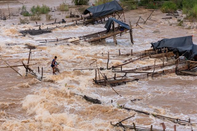 (260711) -- CHAMPASAK, July 11, 2026 (Xinhua) -- A fisherman catches fish in the Mekong River in Champasak Province, Laos, July 10, 2026. Champasak Province in southern Laos is home to the final section of the Mekong River running through the country, and well noted for a diverse array of river fish and rich aquatic resources. Many locals rely on fishing for their livelihood. (Photo by Kaikeo Saiyasane/Xinhua)