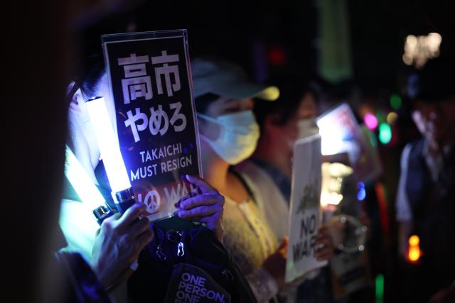 (260711) -- TOKYO, July 11, 2026 (Xinhua) -- People holding signs attend a protest rally in front of the National Diet Building in Tokyo, Japan, July 10, 2026. A large number of Japanese citizens gathered in front of the National Diet Building in Tokyo on Friday evening to protest a series of dangerous policies and bills recently promoted by the government of Prime Minister Sanae Takaichi. (Xinhua/Yue Chenxing)