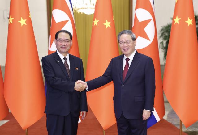 (260711) -- BEIJING, July 11, 2026 (Xinhua) -- Chinese Premier Li Qiang, also a member of the Standing Committee of the Political Bureau of the Communist Party of China (CPC) Central Committee, holds talks with Pak Thae Song, premier of the Cabinet of the Democratic People's Republic of Korea (DPRK), also a member of the Presidium of the Political Bureau of the Central Committee of the Workers' Party of Korea and vice president of the State Affairs Commission of the DPRK, at the Great Hall of the People in Beijing, capital of China, July 11, 2026. (Xinhua/Huang Jingwen)