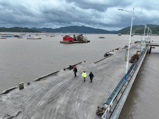 (260711) -- FUDING, July 11, 2026 (Xinhua) -- An aerial drone photo taken on July 11, 2026 shows village officials and rescuers patrolling at a port in Shacheng Town of Fuding, southeast China's Fujian Province.
  Fujian has maintained its Level II typhoon emergency response and activated a Level III flood control emergency response as Typhoon Bavi nears China's east coast on Saturday.
 Local officials have implemented precautionary measures to prevent the Typhoon Bavi, including evacuating residents and inspecting geological hazard sites. Temporary shelters were fully stocked with supplies and medical resources. (Xinhua/Jiang Kehong)