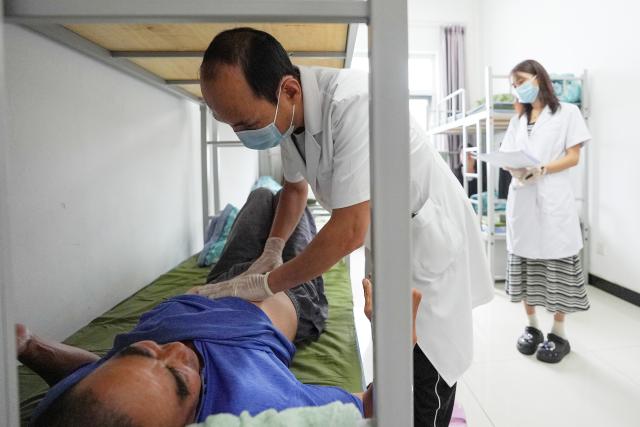 (260711) -- BEIJING, July 11, 2026 (Xinhua) -- A doctor conducts a physical examination for a local resident at a temporary shelter in Miyun District in Beijing, capital of China, July 11, 2026.
  Beijing is still under a Level II flood control emergency response as continuous heavy rainfall lashes the city, with eight of its districts activating the highest level flood response. As of Saturday morning, the city had evacuated 104,042 residents, shut down 181 tourist attractions and 4,311 rural homestays, with 27,418 rescue workers on standby to handle disasters such as mountain floods and landslides. (Xinhua/Ju Huanzong)