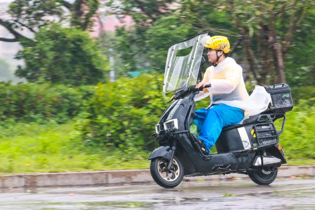 (260711) -- WENZHOU, July 11, 2026 (Xinhua) -- A deliveryman rides amid wind and rain in Yueqing of Wenzhou, east China's Zhejiang Province, July 11, 2026. Zhejiang Province in east China raised its typhoon emergency response to the highest level on Saturday as Typhoon Bavi, the 9th typhoon of 2026, barrels toward the country's eastern coast, triggering widespread disaster prevention efforts across multiple provincial-level regions. 
  According to Zhejiang Meteorological Observatory, the severe typhoon was located some 489 km off the coast of the province's city of Wenzhou as of 9 a.m. on Saturday, packing strong-typhoon-level winds near its center. It is forecast to move northwest at a speed of 30 to 35 km per hour and make landfall in Zhejiang around midnight. (Xinhua/Jiang Han)